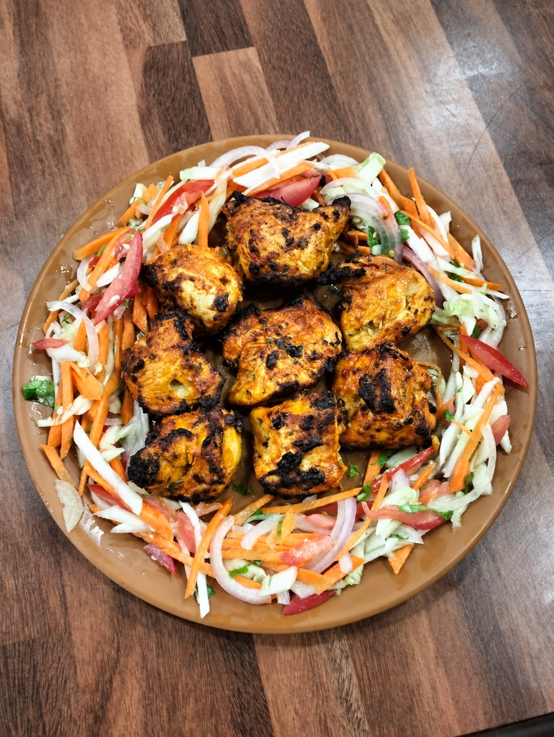 A freshly grilled dish served with a colourful salad at Mohammad Restaurant